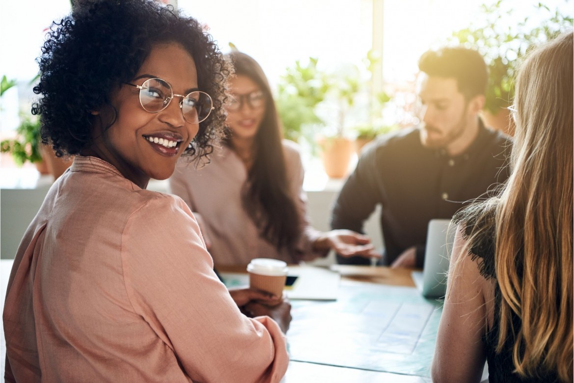 smiling woman happy about the diversity in the workplace that her company has